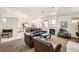 Open-concept living room with comfortable seating, a fireplace, and access to the dining area and kitchen at 7515 Splashing Rock Dr, Las Vegas, NV 89131