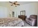 Carpeted main bedroom with a ceiling fan, natural light, and en suite bathroom at 7515 Splashing Rock Dr, Las Vegas, NV 89131