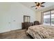 Main bedroom featuring a ceiling fan, plush carpet, and sliding glass doors to the backyard at 7515 Splashing Rock Dr, Las Vegas, NV 89131