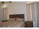 A bedroom featuring a wooden bed frame, ceiling fan, and neutral color palette at 7515 Splashing Rock Dr, Las Vegas, NV 89131