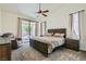 Main bedroom with a ceiling fan, plush carpet, sliding glass doors, and ensuite bathroom at 7515 Splashing Rock Dr, Las Vegas, NV 89131