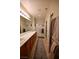 En-suite bathroom featuring double sinks, a walk-in shower, and neutral-toned decor at 7727 Widewing Dr, North Las Vegas, NV 89084