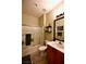 Features a tub shower combo, tile floors, toilet, wood cabinet vanity, and decorative shelves at 7727 Widewing Dr, North Las Vegas, NV 89084