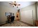 Shows the bedroom area with a desk, closet and ceiling fan at 7727 Widewing Dr, North Las Vegas, NV 89084