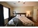 Comfortable bedroom with ceiling fan, window with black-out curtains, and a bed with patterned comforter at 7727 Widewing Dr, North Las Vegas, NV 89084
