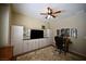 Shows a bedroom area with a ceiling fan, cabinets, and desk at 7727 Widewing Dr, North Las Vegas, NV 89084