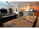 Open-concept dining area with wood table, neutral decor, and seamless flow into living room and kitchen at 7727 Widewing Dr, North Las Vegas, NV 89084
