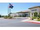 Exterior view of a commercial building named Sun City Aliante, flags and well-maintained landscaping at 7727 Widewing Dr, North Las Vegas, NV 89084