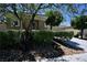 Well-maintained home exterior with mature trees and manicured shrubs at 7727 Widewing Dr, North Las Vegas, NV 89084