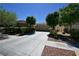 Inviting home exterior featuring a wide driveway, lush landscaping, and a two-car garage at 7727 Widewing Dr, North Las Vegas, NV 89084