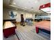 Well-equipped game room featuring shuffleboard, a pool table, dart board, and comfortable seating at 7727 Widewing Dr, North Las Vegas, NV 89084