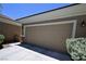 Attached two-car garage with neutral door and manicured landscaping at 7727 Widewing Dr, North Las Vegas, NV 89084