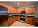Stylish kitchen showcasing stainless steel appliances, ample storage, and granite countertops at 7727 Widewing Dr, North Las Vegas, NV 89084