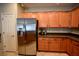 Charming kitchen featuring stainless steel refrigerator, ample cabinets, and functional layout at 7727 Widewing Dr, North Las Vegas, NV 89084