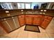 Features a stainless steel dishwasher and a granite countertop with medium toned wood cabinets at 7727 Widewing Dr, North Las Vegas, NV 89084