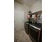 A spacious laundry room featuring modern front-loading washer and dryer and ample shelving at 7727 Widewing Dr, North Las Vegas, NV 89084