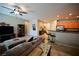 Living room showcasing a cozy sectional sofa and views into the kitchen with bar seating at 7727 Widewing Dr, North Las Vegas, NV 89084