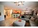 Inviting living room with a large sectional sofa, and views into the open kitchen and dining space at 7727 Widewing Dr, North Las Vegas, NV 89084