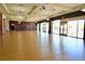 Large meeting room with hardwood floors, expansive windows for natural light, and neutral decor at 7727 Widewing Dr, North Las Vegas, NV 89084