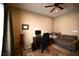 This room has a ceiling fan, a desk with computer, a sofa, and a telescope at 7727 Widewing Dr, North Las Vegas, NV 89084