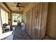 Covered sun room with ceiling fan, sliding glass doors, and decorative wrought iron security doors at 7727 Widewing Dr, North Las Vegas, NV 89084