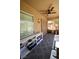 Enclosed sun room has a ceiling fan, a storage closet and a table with chairs at 7727 Widewing Dr, North Las Vegas, NV 89084