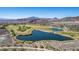Scenic aerial view of a lush golf course community featuring a serene lake and rolling green fairways against a mountain backdrop at 8 Via Tiberina, Las Vegas, NV 89011