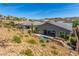 View of the backyard featuring a pool, desert landscaping, and outdoor living in a hillside community at 8 Via Tiberina, Las Vegas, NV 89011
