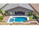 A backyard featuring a pool, rock waterfall slide, and desert landscaping. Perfect for outdoor entertaining at 8 Via Tiberina, Las Vegas, NV 89011
