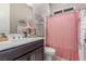 Bathroom with a shower, vanity, storage shelves, a mirror, and a cabinet with double doors at 8 Via Tiberina, Las Vegas, NV 89011
