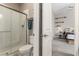 Bathroom featuring a glass shower, toilet, neutral paint, and view into bedroom at 8 Via Tiberina, Las Vegas, NV 89011