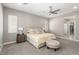 Serene main bedroom suite featuring plush carpet, a ceiling fan, and natural light at 8 Via Tiberina, Las Vegas, NV 89011