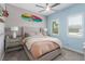 Light-filled bedroom with a ceiling fan, a surfboard, side tables, and two windows with plantation shutters at 8 Via Tiberina, Las Vegas, NV 89011