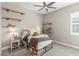 Bedroom with floating shelves, ceiling fan, carpet and a bed with a rustic wooden headboard at 8 Via Tiberina, Las Vegas, NV 89011