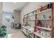 Bedroom with a desk, chair, shelving, and view into another room with a grey easy chair and small table at 8 Via Tiberina, Las Vegas, NV 89011