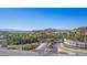Entrance to Lake Las Vegas featuring lush landscaping, palm trees, and a scenic bridge at 8 Via Tiberina, Las Vegas, NV 89011
