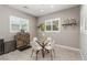 Cozy breakfast nook with a glass table, modern chairs, and two large shuttered windows at 8 Via Tiberina, Las Vegas, NV 89011