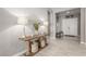 Welcoming entryway with wood-look tile flooring, console table and a front door in the background at 8 Via Tiberina, Las Vegas, NV 89011