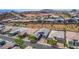 An elevated view showcasing a neighborhood with well-maintained houses nestled in a desert landscape with mountain views at 8 Via Tiberina, Las Vegas, NV 89011