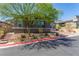 Charming single-story home featuring manicured landscaping, mature trees, and a brick driveway at 8 Via Tiberina, Las Vegas, NV 89011