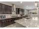 Bright kitchen with stainless appliances, dark cabinets, granite countertops, and a large island at 8 Via Tiberina, Las Vegas, NV 89011
