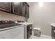 Laundry room featuring a washer, dryer, dark cabinets, tile floor, and neutral paint at 8 Via Tiberina, Las Vegas, NV 89011