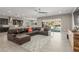 Open-concept living room featuring an oversized leather couch with a view of the backyard pool at 8 Via Tiberina, Las Vegas, NV 89011