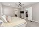Spacious main bedroom with a ceiling fan, a guitar, television, and a door leading to another room at 8 Via Tiberina, Las Vegas, NV 89011