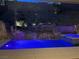 Custom pool with a rock waterfall feature and integrated spa, perfect for relaxation and entertaining at night at 8 Via Tiberina, Las Vegas, NV 89011