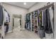 Well-organized walk-in closet with custom shelving, clothing racks, carpeted floors, and a mirror at 8 Via Tiberina, Las Vegas, NV 89011