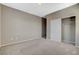 Bright bedroom featuring neutral walls, carpet floors, and a closet with sliding doors at 8486 Insignia Ave # 101, Las Vegas, NV 89178