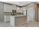 Bright kitchen features white cabinets, stainless appliances, granite countertops, and a functional center island at 8486 Insignia Ave # 101, Las Vegas, NV 89178