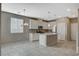 Modern kitchen featuring an island with sink, stainless appliances, and ample storage at 8486 Insignia Ave # 101, Las Vegas, NV 89178