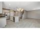Bright kitchen and dining area featuring granite counters, stainless appliances, and tile floor at 8486 Insignia Ave # 101, Las Vegas, NV 89178